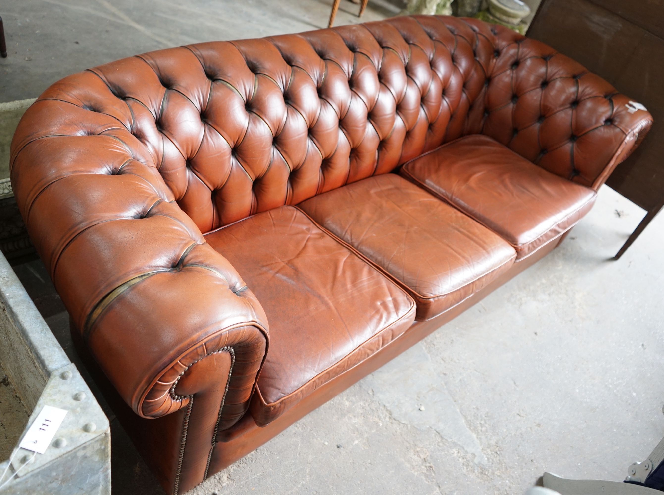 A modern Victorian style buttoned brown leather Chesterfield settee, length 200cm, depth 82cm, height 68cm